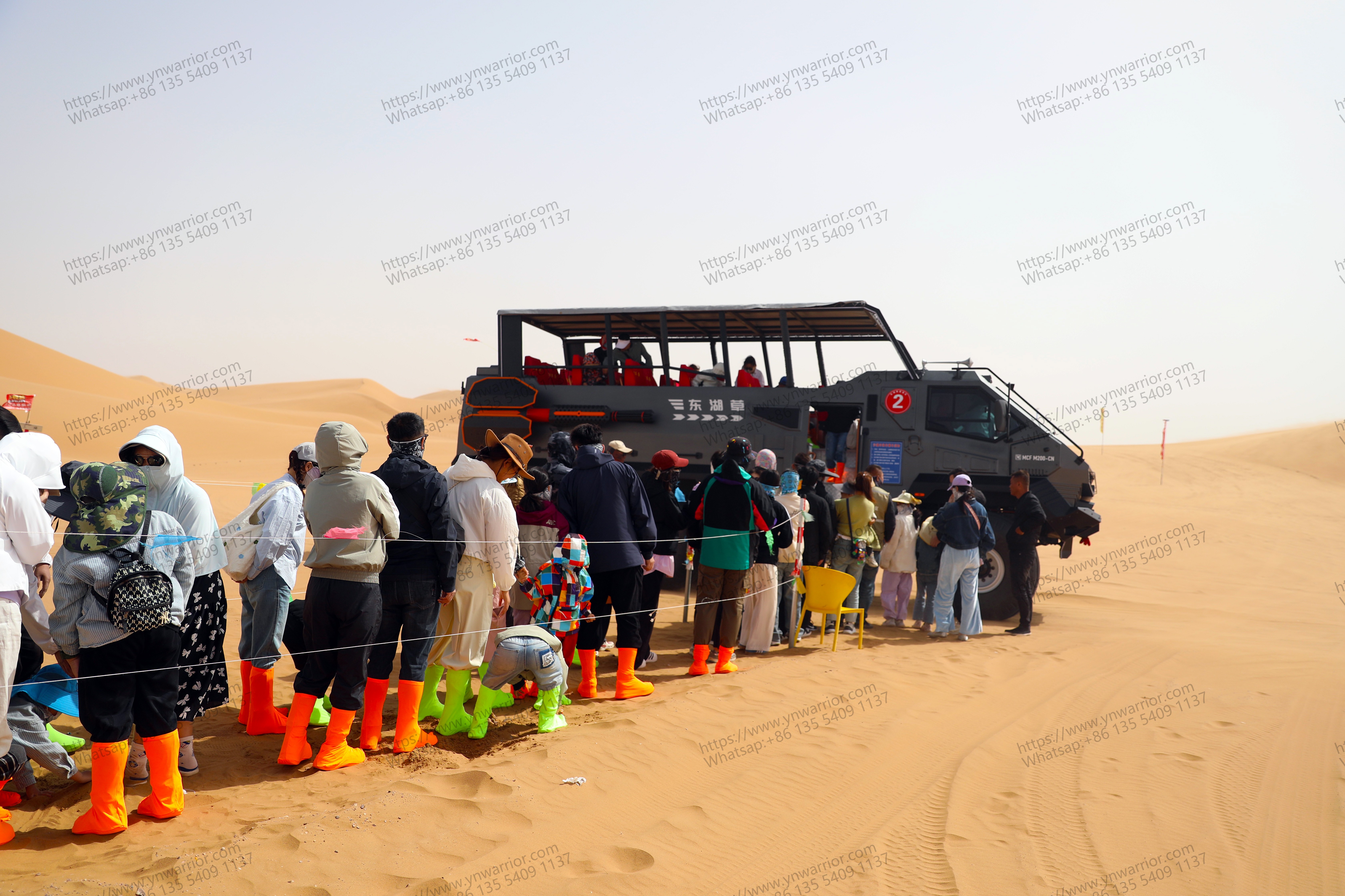 many people waiting for get aboard in desert cruiser bus