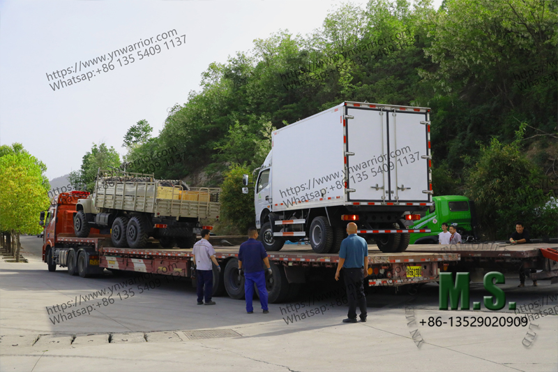worker testing the truck on the low bed trailer