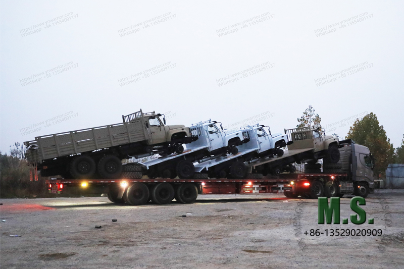 Dongfeng trucks sitting on the back of big low bed trailer truck